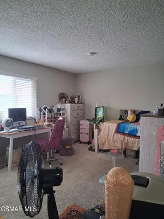 a living room with furniture a rug and a table