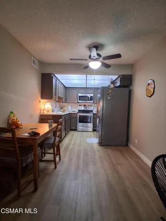 a view of a dining room with furniture and wooden floor