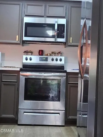 a stove top oven sitting inside of a kitchen