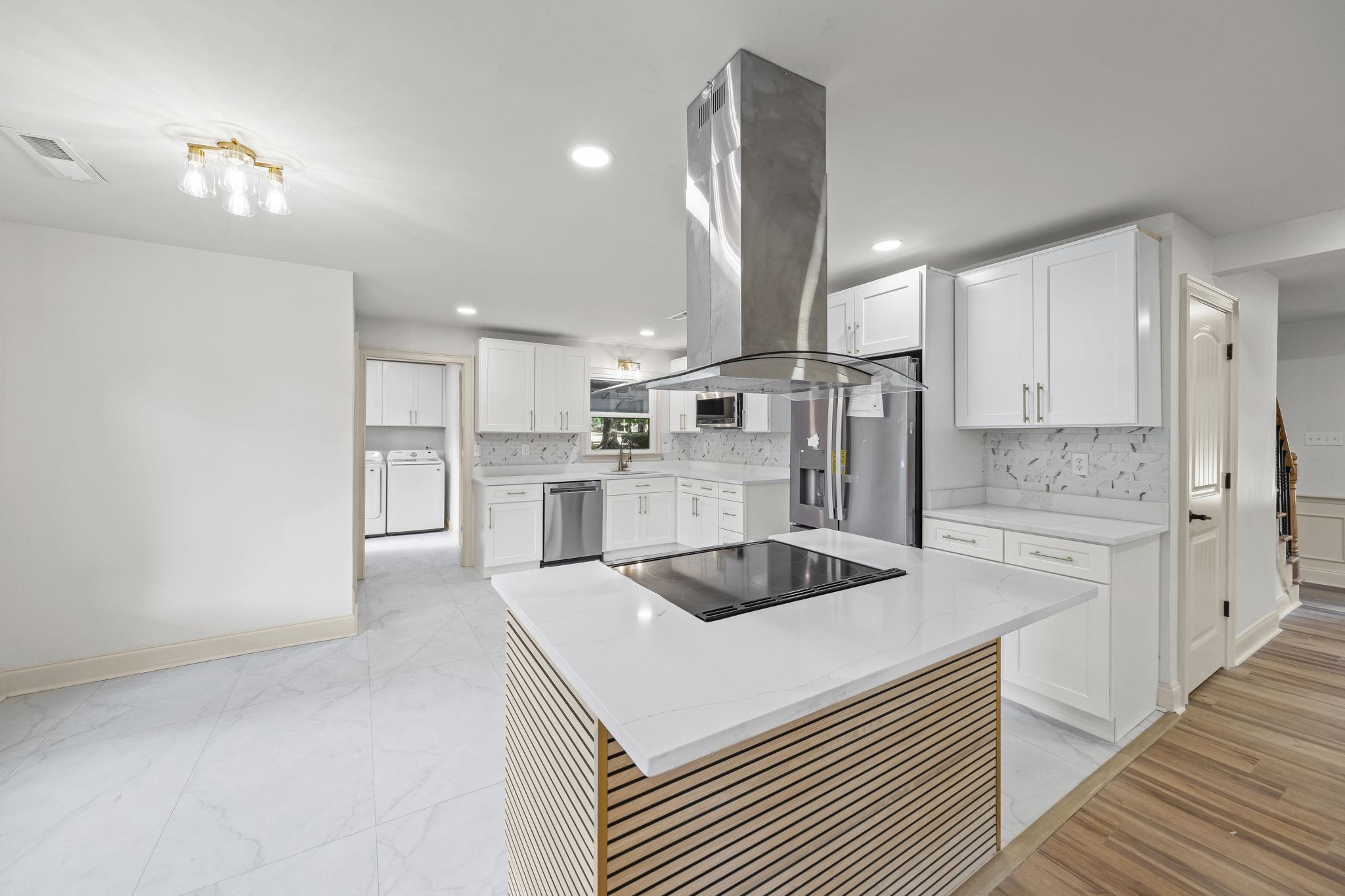 7086 McVay Road Germantown, TN 38138 - Photo 16 of 40 a kitchen with kitchen island a sink stainless steel appliances and cabinets