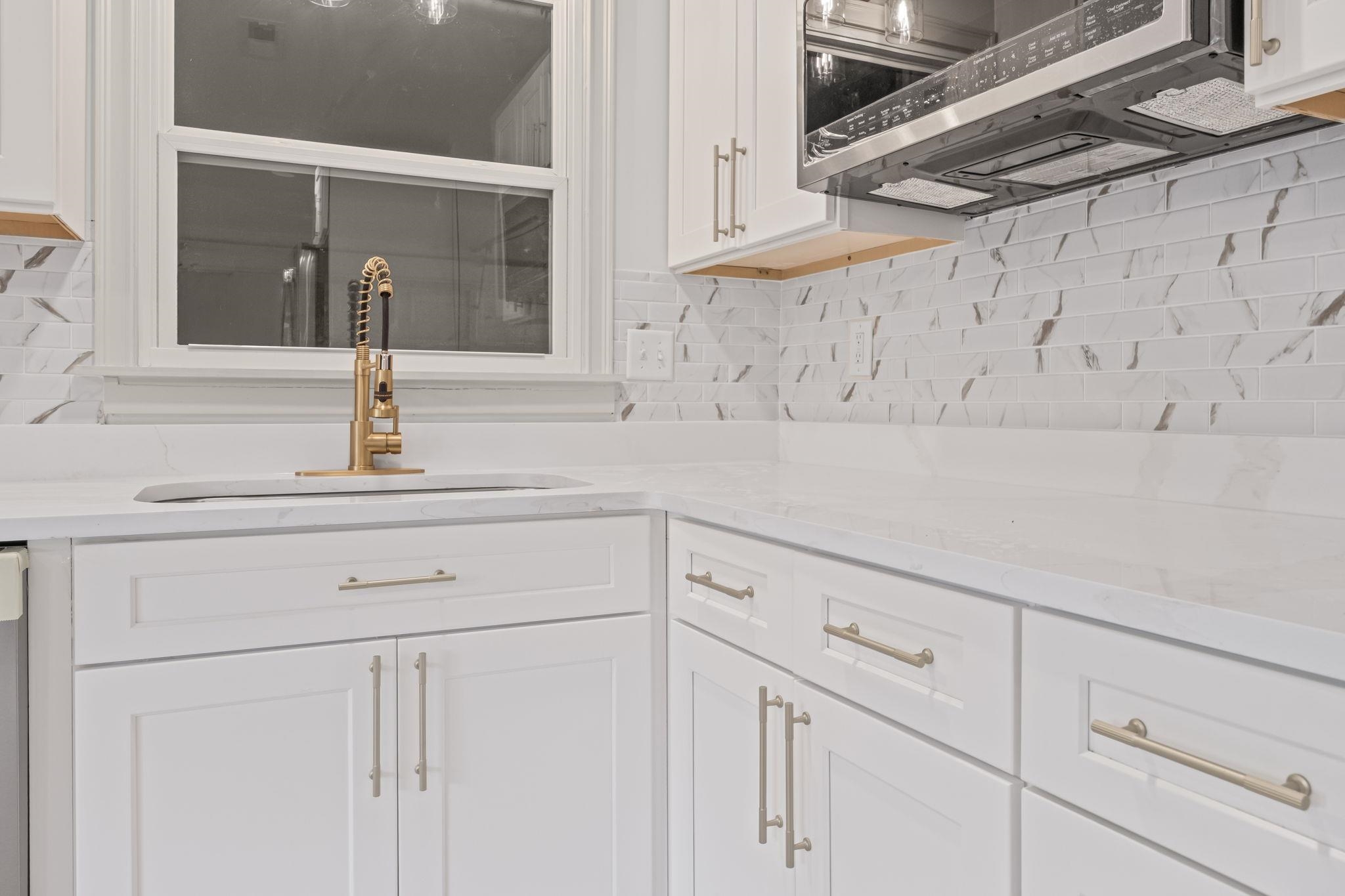 7086 McVay Road Germantown, TN 38138 - Photo 19 of 40 a kitchen with white cabinets and white appliances