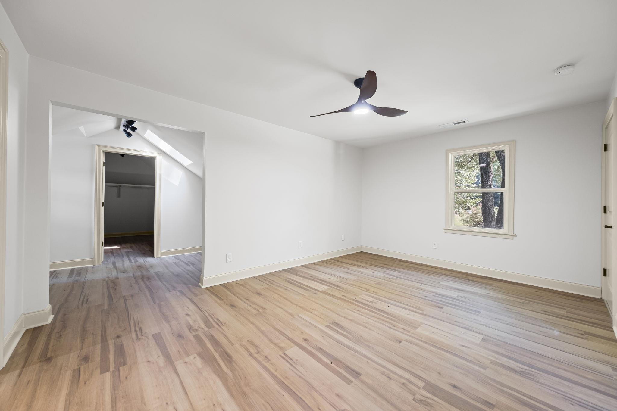 7086 McVay Road Germantown, TN 38138 - Photo 21 of 40 a view of an empty room with wooden floor and a window