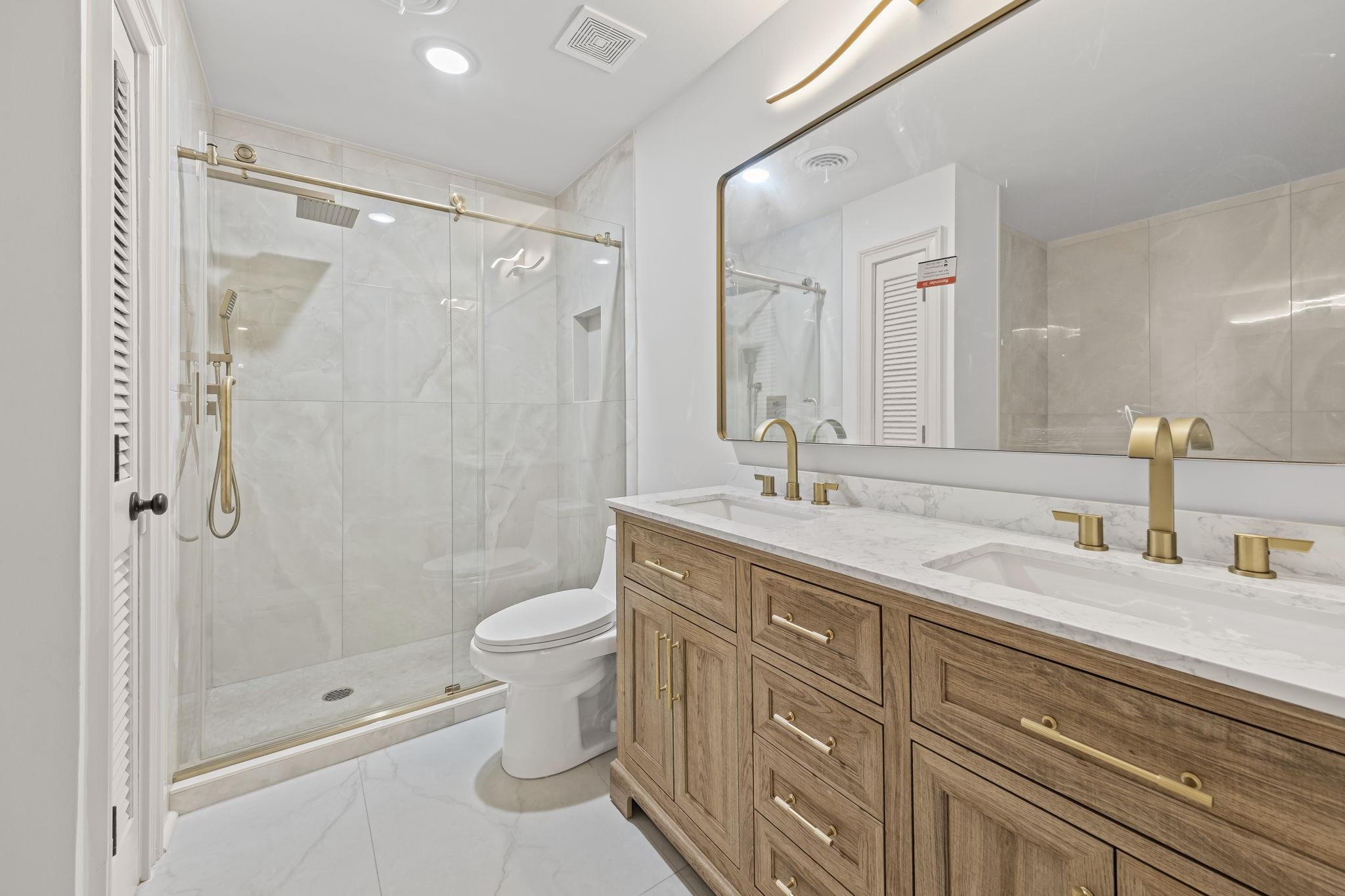 7086 McVay Road Germantown, TN 38138 - Photo 25 of 40 a bathroom with a double vanity sink toilet and shower