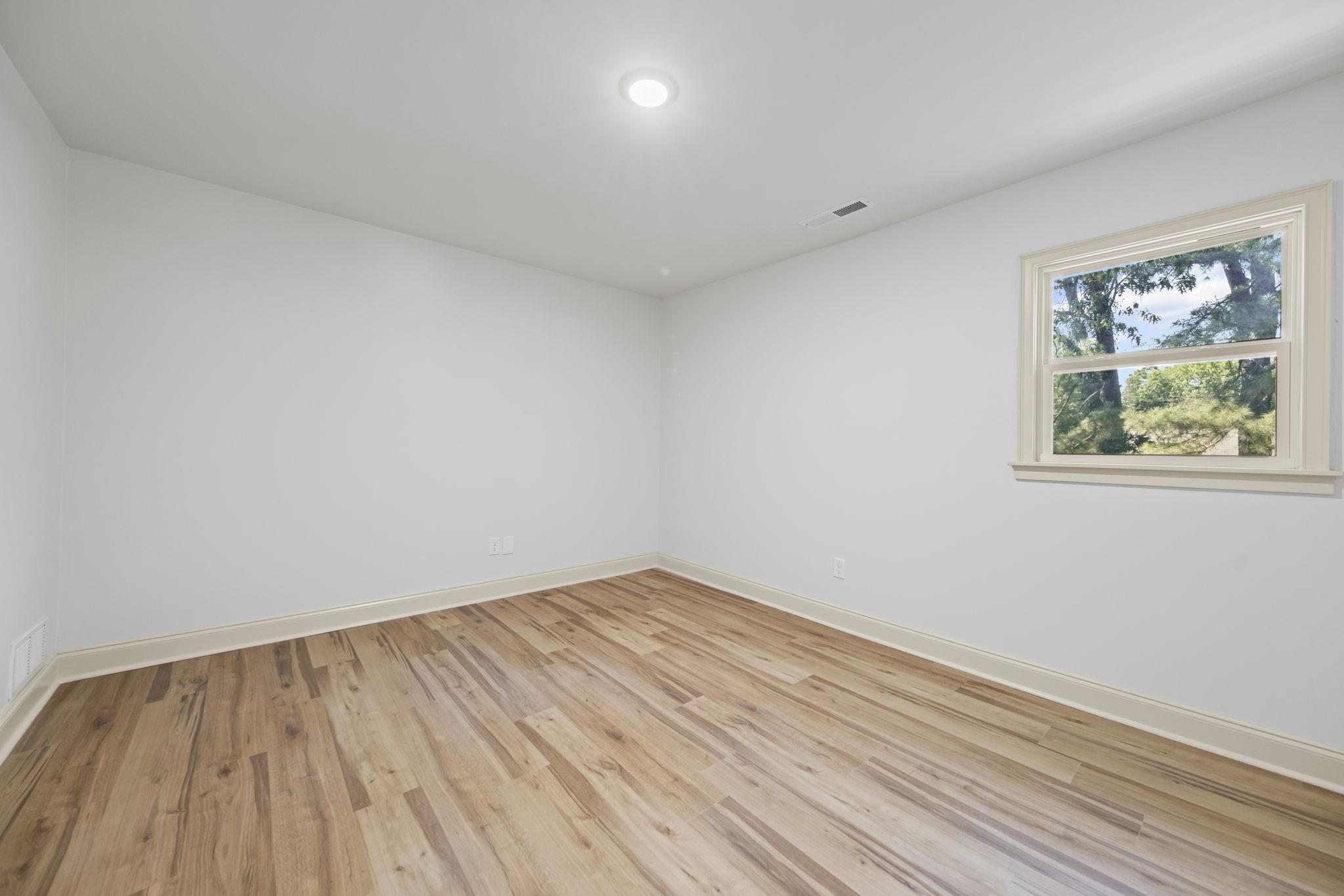 7086 McVay Road Germantown, TN 38138 - Photo 30 of 40 a view of room with wooden floor and window