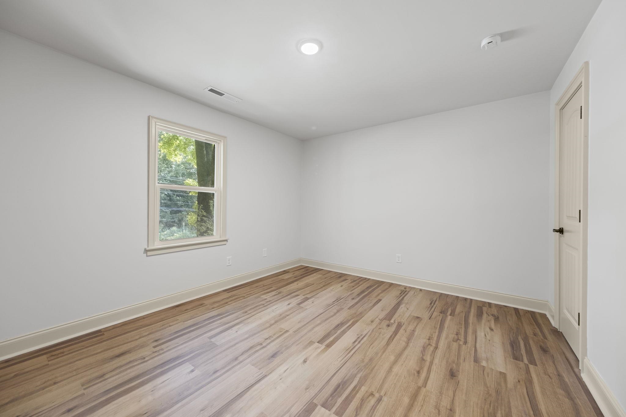 7086 McVay Road Germantown, TN 38138 - Photo 31 of 40 wooden floor in an empty room with a window