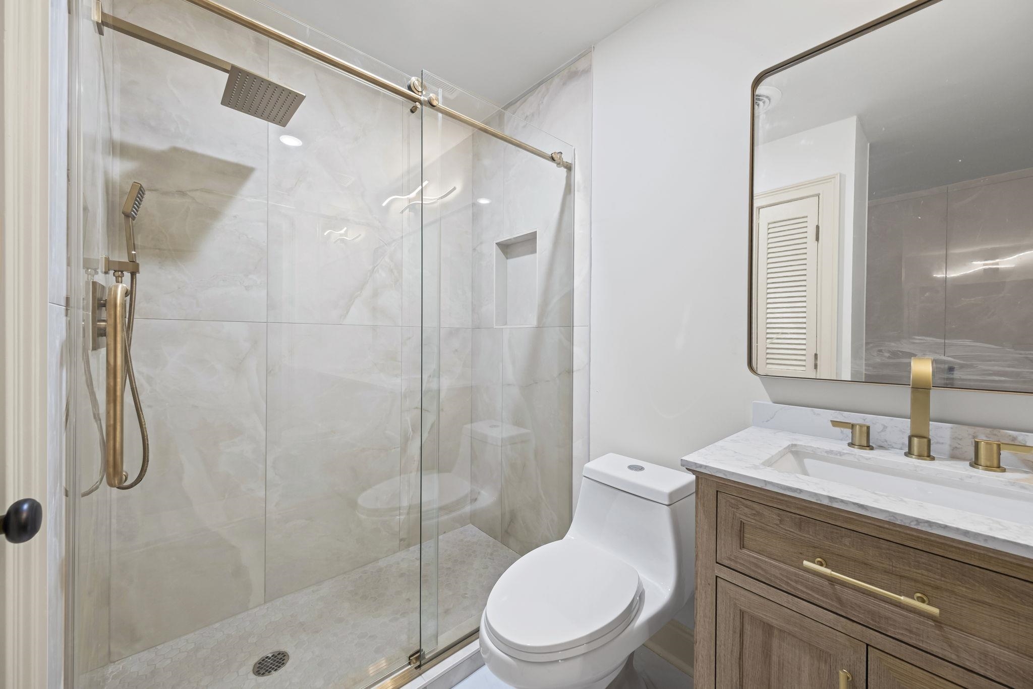 7086 McVay Road Germantown, TN 38138 - Photo 34 of 40 Primary bathroom with a stall shower and double vanity. Gold fixtures