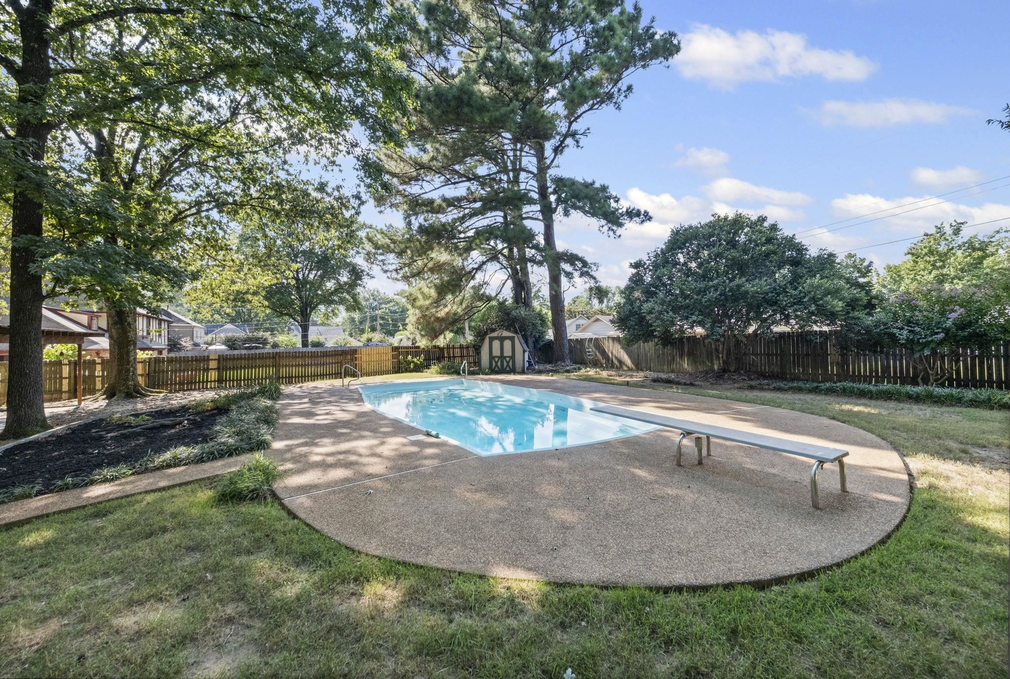 7086 McVay Road Germantown, TN 38138 - Photo 8 of 40 a view of a swimming pool with a yard