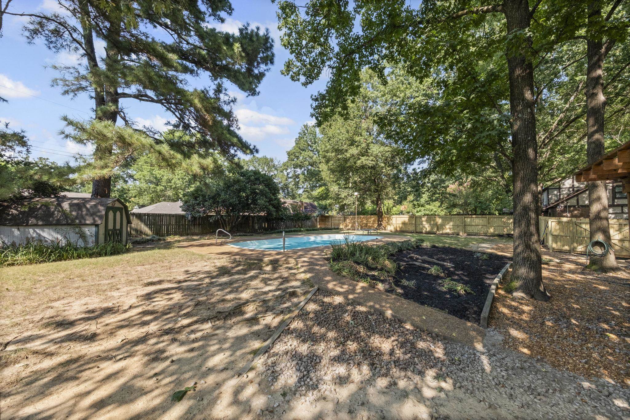 7086 McVay Road Germantown, TN 38138 - Photo 9 of 40 a backyard of a house with lots of green space