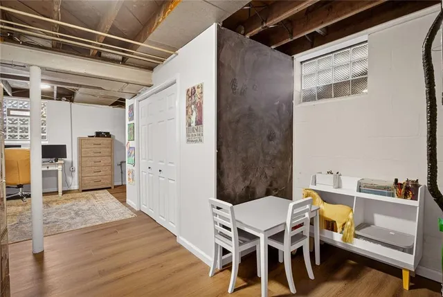 a dining room with furniture and wooden floor