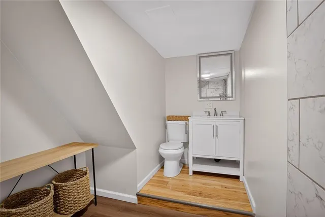 a bathroom with a sink toilet and a mirror