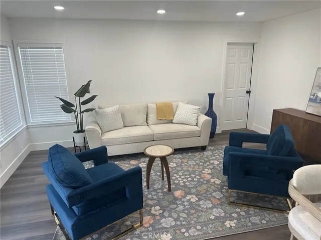 a living room with furniture and a rug
