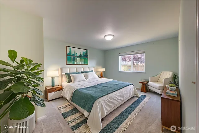 a bedroom with a bed and a potted plant