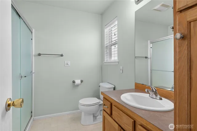 a bathroom with a sink a toilet and a mirror