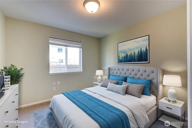 a bedroom with a bed and a potted plant