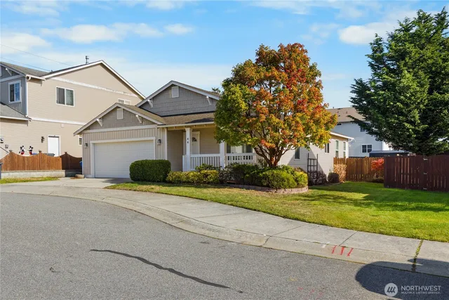a view of backyard of house with green space