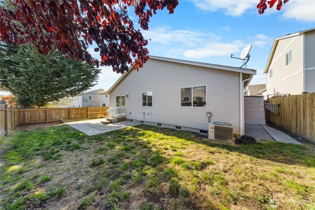 a front view of a house with a garden and garage