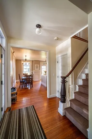 a view of entryway livingroom and hall with wooden floor