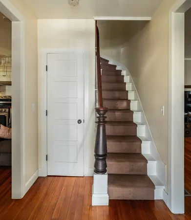 a view of entryway with wooden floor and stairs