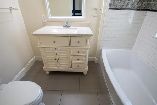 a bathroom with a sink a toilet and bathtub