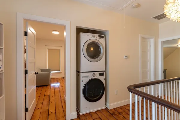 a view of a bedroom with washer and dryer