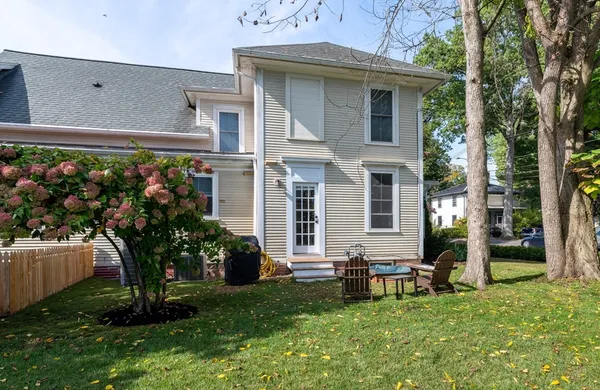 a view of a house with backyard sitting area and garden