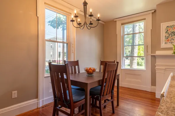 a view of a dining room with furniture window and wooden floor