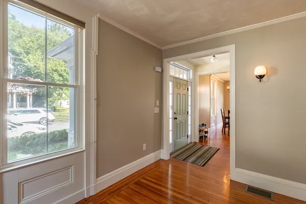 a view of wooden floor and windows in a room