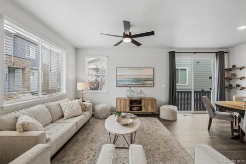 a living room with furniture two window and a table