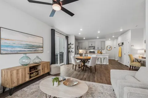 a living room with furniture and kitchen view