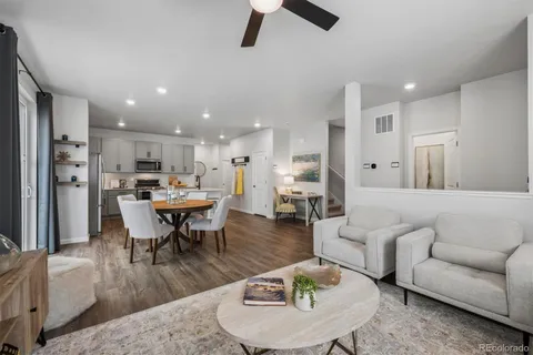 a living room with furniture kitchen view and a dining table