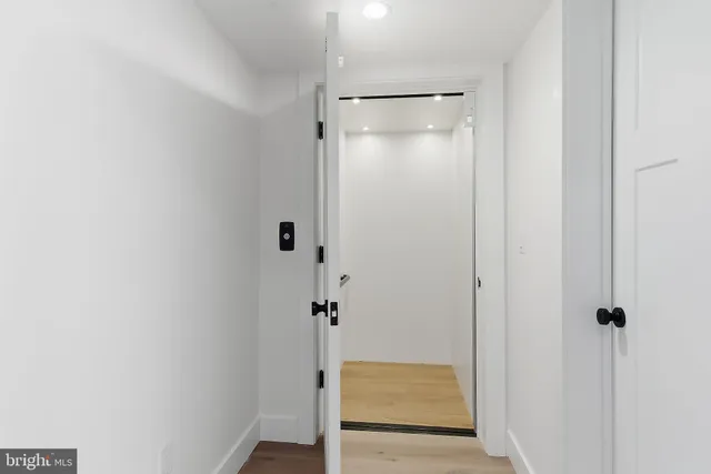 a bathroom with a granite countertop sink a toilet a mirror and shower
