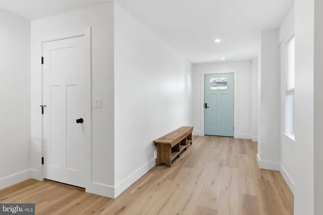 a bedroom with a bed and a flat tv screen on the dresser