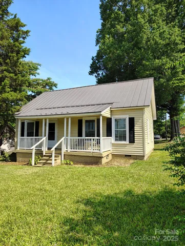 a front view of a house with garden and porch
