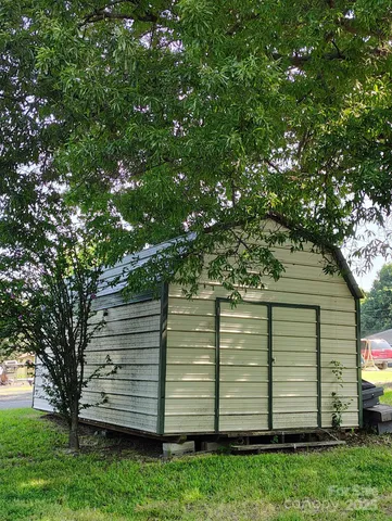 a view of a backyard with a large tree