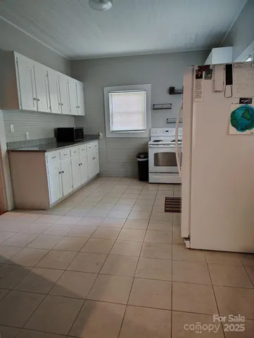a kitchen with a stove a sink and a refrigerator