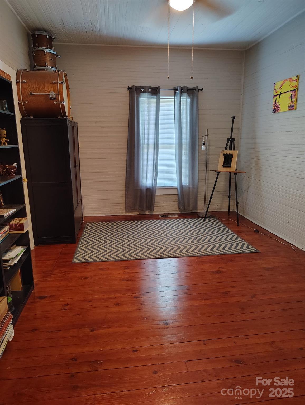 8504 Moores Chapel Road Charlotte, NC 28214 - Photo 9 of 14 an empty room with wooden floor and staircase