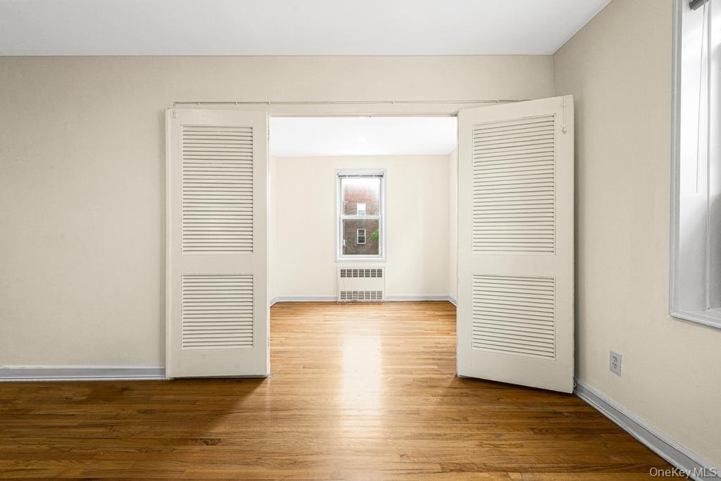 72-10 112th Street, Unit 5B Queens, NY 11375 - Photo 13 of 27 a view of wooden floor and windows in a room