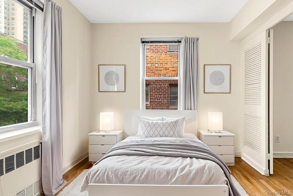 72-10 112th Street, Unit 5B Queens, NY 11375 - Photo 14 of 27 a bedroom with a bed and a window