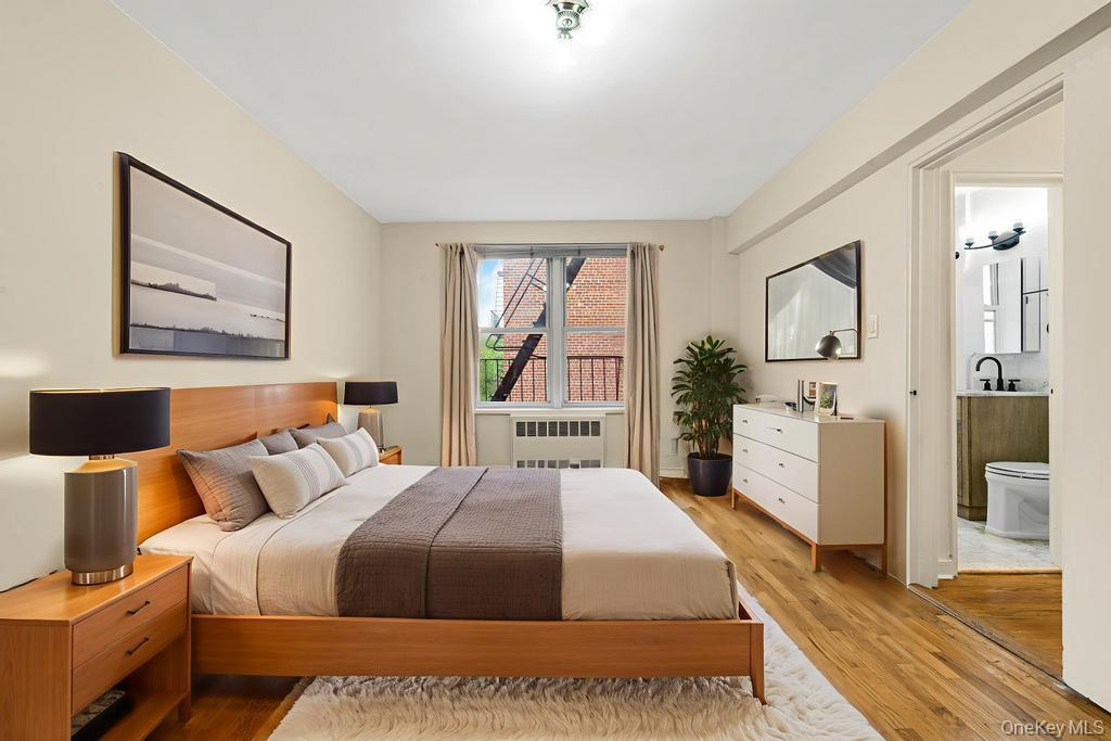 72-10 112th Street, Unit 5B Queens, NY 11375 - Photo 22 of 27 a spacious bedroom with a bed and a large mirror