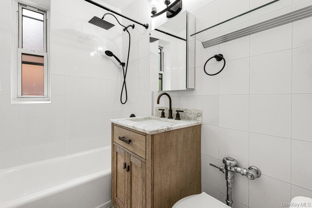 72-10 112th Street, Unit 5B Queens, NY 11375 - Photo 26 of 27 a bathroom with a granite countertop sink a toilet and shower
