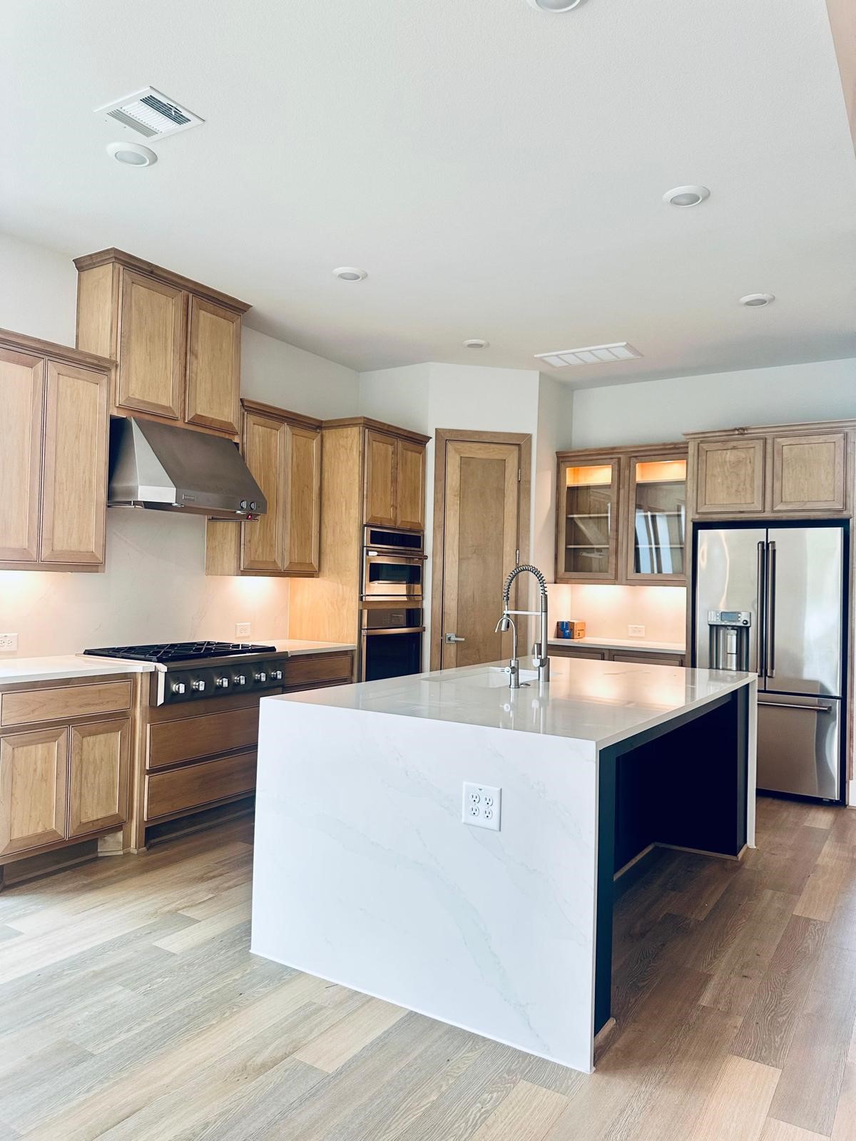 6 Gentle Branch Place Tomball, TX 77375 - Photo 26 of 46 a kitchen with stainless steel appliances granite countertop a stove and a sink