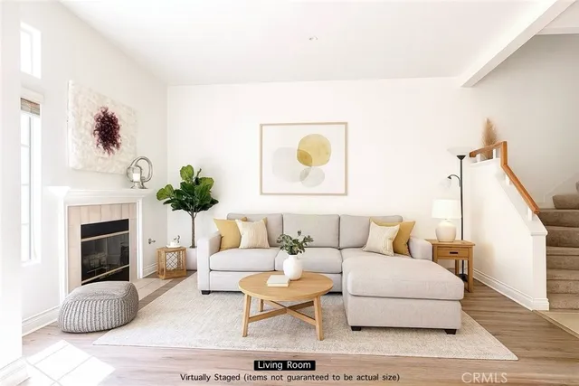 a living room with furniture a fireplace and a potted plant