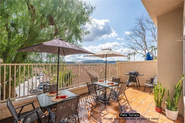 an outdoor space with furniture and umbrella