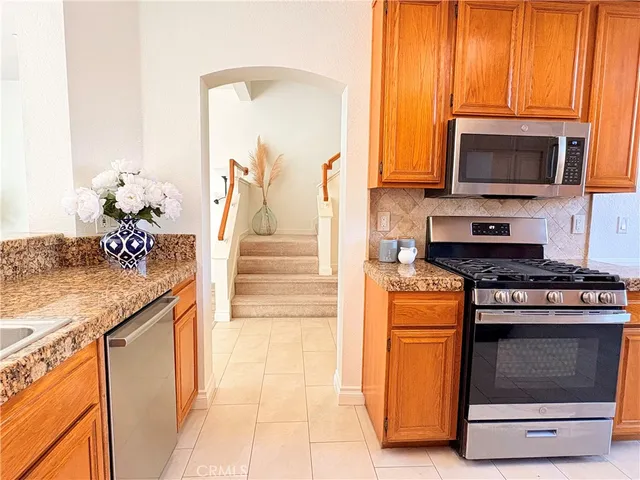 a kitchen with stainless steel appliances granite countertop a stove and a microwave