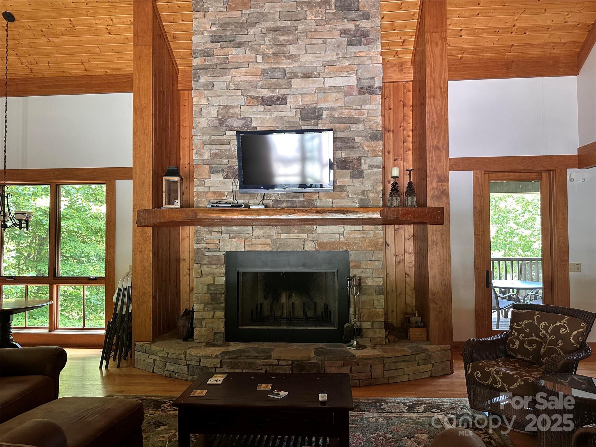 66 Boone Cove Road Zirconia, NC 28790 - Photo 11 of 15 a living room with furniture a large window and a fireplace