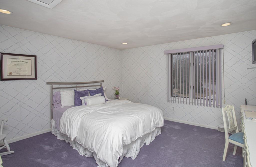30 Aspen Road Sharon, MA 02067 - Photo 13 of 24 a bedroom with a bed a chair and next to a window