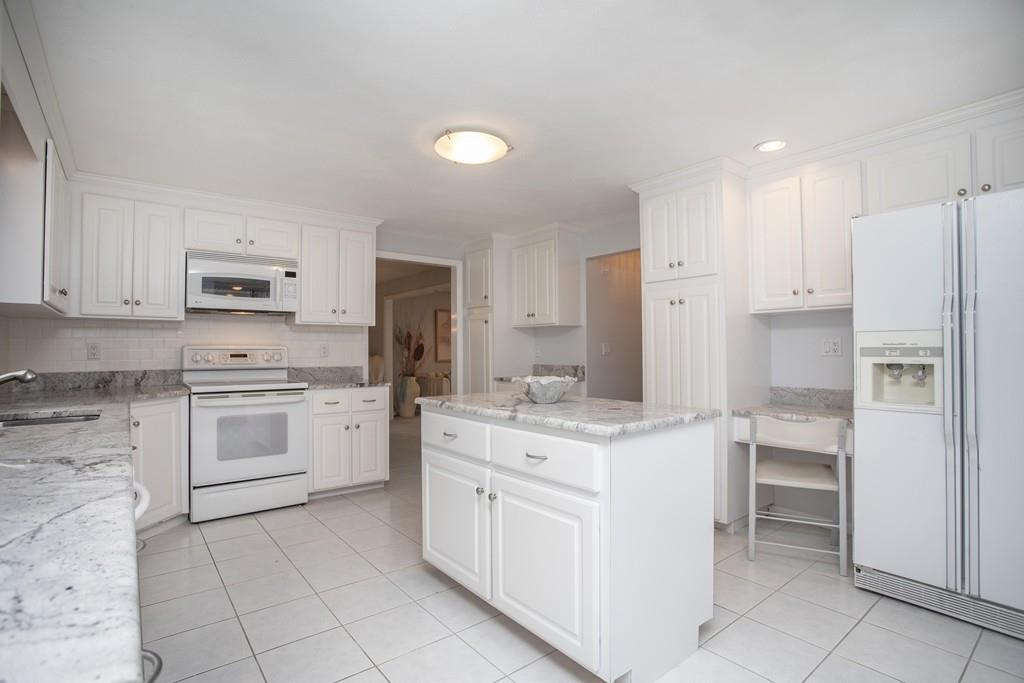 30 Aspen Road Sharon, MA 02067 - Photo 5 of 24 a kitchen with white cabinets and white appliances