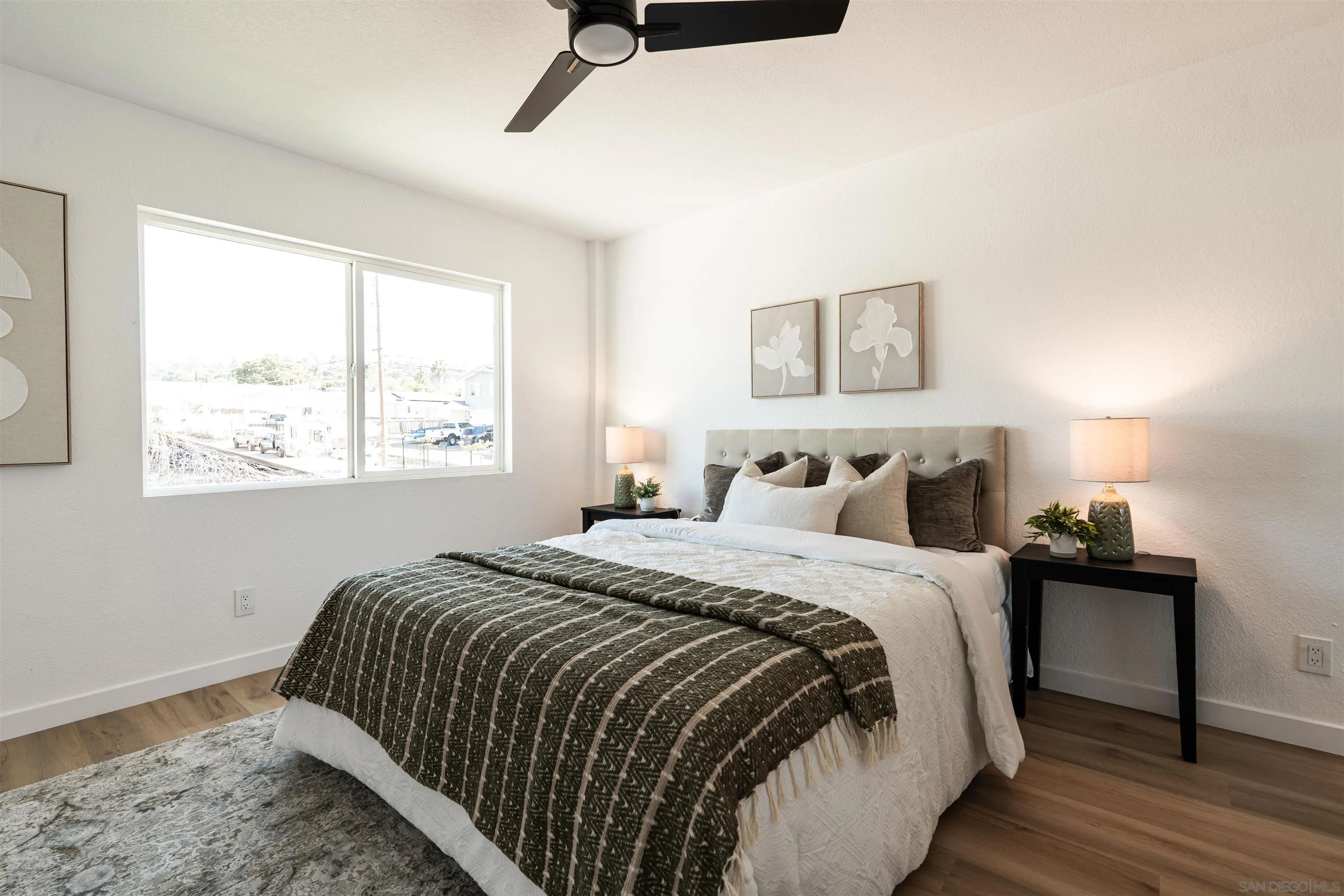 3101 King Arthurs Court Spring Valley, CA 91977 - Photo 24 of 40 a bedroom with a bed and wooden floor