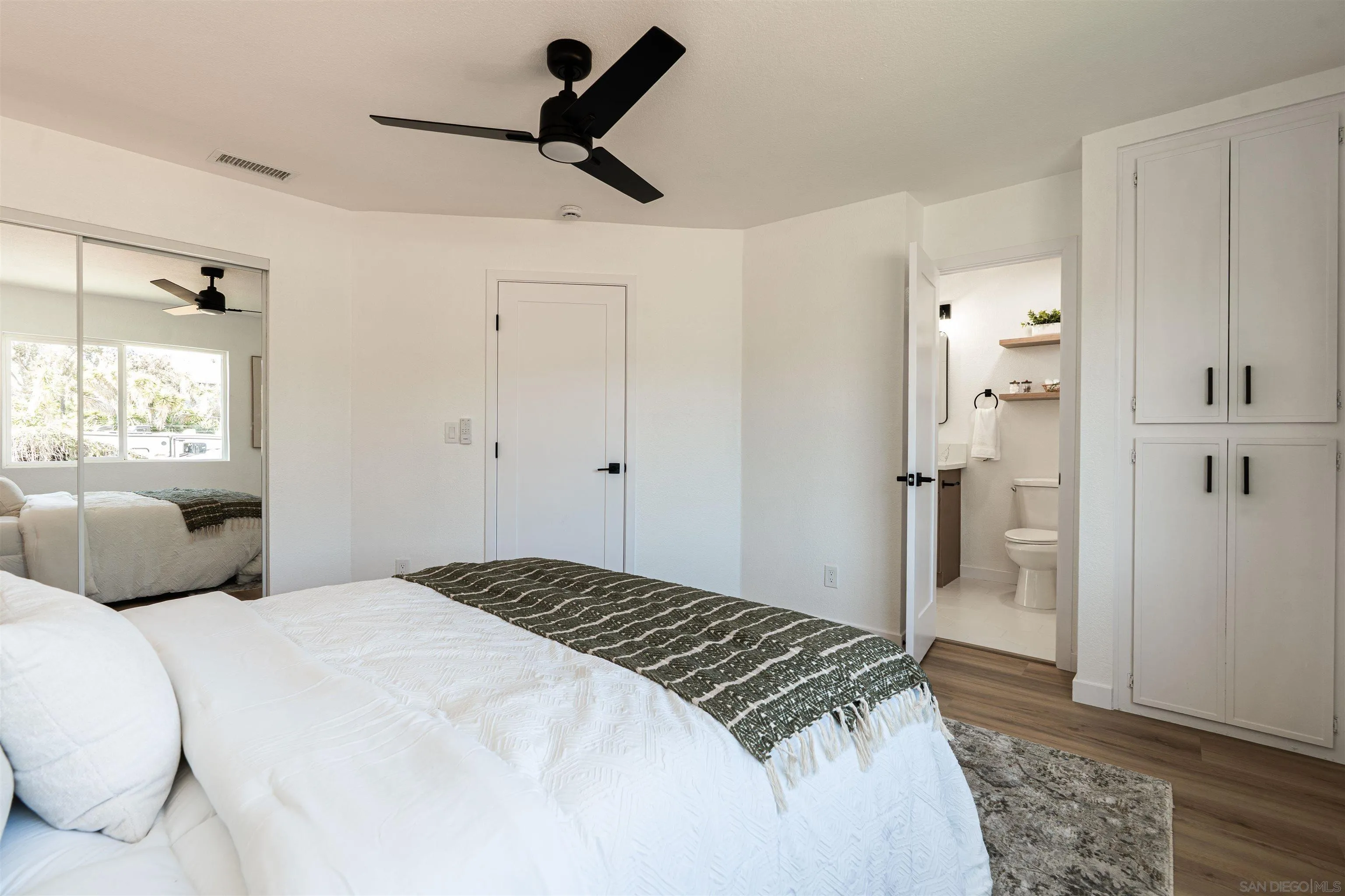 3101 King Arthurs Court Spring Valley, CA 91977 - Photo 26 of 40 a bedroom with a bed and a walk in closet