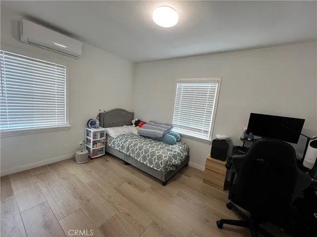 a bedroom with bed and window